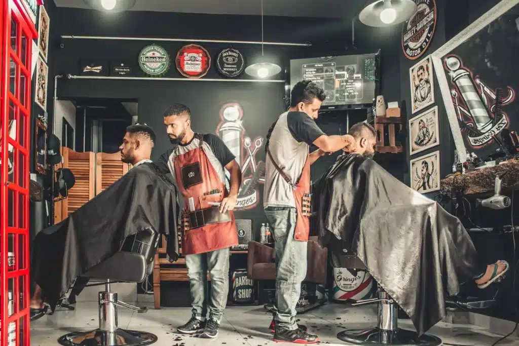two barbers working in a barber shop one of the jobs ai will never replace