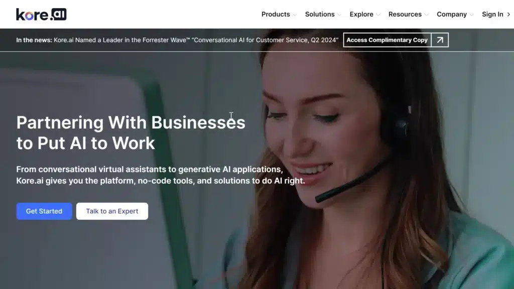 Kore.ai homepage featuring a woman wearing a headset, representing their partnership with businesses to implement AI solutions. The page includes buttons to 'Get Started' and 'Talk to an Expert'